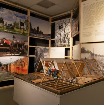 Muzei Istorii Mista Kyieva in Kyiv - exhibition installation with wooden structures and photos documenting a historical tent camp protest