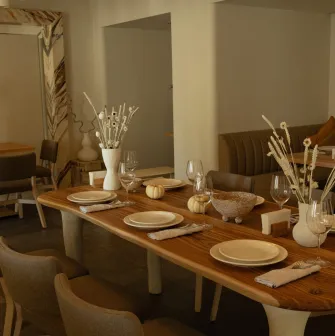 Restaurant Odesa - spacious dining room with a large wooden table set for a meal