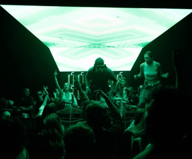 Stage with a DJ at the Juice / NoCap club in Kyiv with bright green lighting