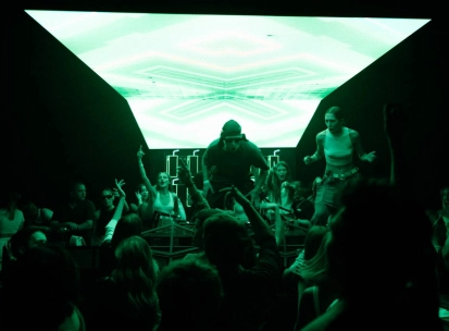 Stage with a DJ at the Juice / NoCap club in Kyiv with bright green lighting
