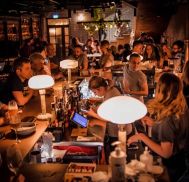 Pab Kedy - busy bar counter with bartenders serving drinks to many guests