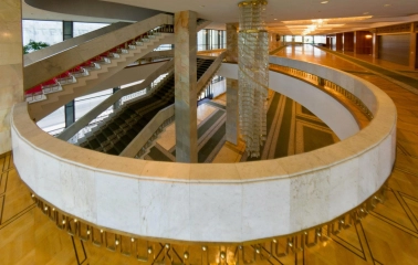Palats Ukraina in Kyiv - elegant marble spiral staircase wrapping around a massive crystal chandelier in the foyer