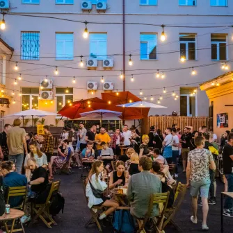 People relaxing on the terrace of the "Hvlv" bar in Podil, Kyiv
