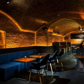 Loggerhead - cozy, dimly lit interior with unique archways and soft wall textures