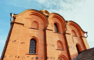 Golden Gate in Kyiv - close-up view of the red brick upper facade with arched niches and decorative stone details