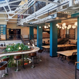 Creative States - modern workspace featuring high ceilings and long desks