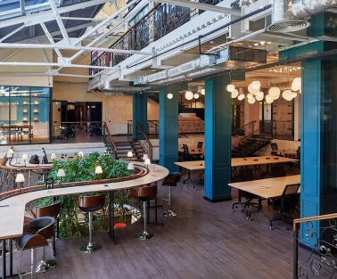 Creative States - modern workspace featuring high ceilings and long desks