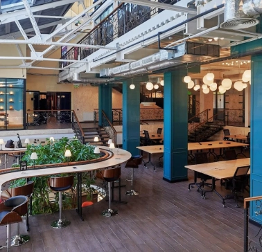 Creative States - modern workspace featuring high ceilings and long desks