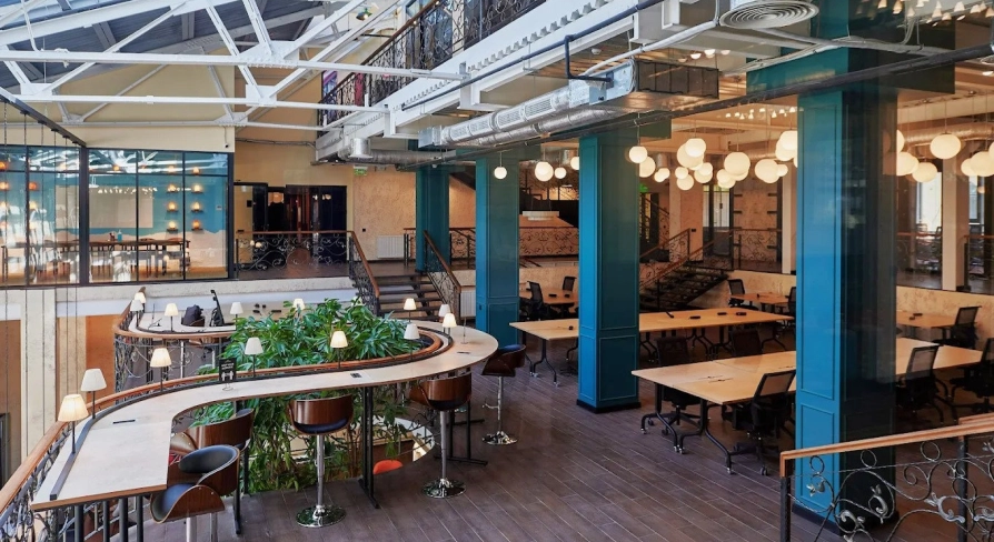 Creative States - modern workspace featuring high ceilings and long desks