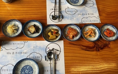 Restaurant Arirang - table set with various Korean appetizers and small bowls