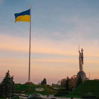Motherland - sunlit steel statue raising a sword and shield to the sky