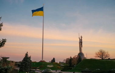 Motherland - sunlit steel statue raising a sword and shield to the sky