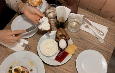 Spelta – cozy breakfast with coffee, bread, cheese and boiled egg on wooden table