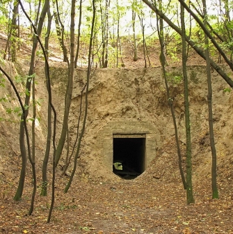 Lysa Hora in Kyiv - entrance to a dark brick tunnel built into the earthen fortification rampart