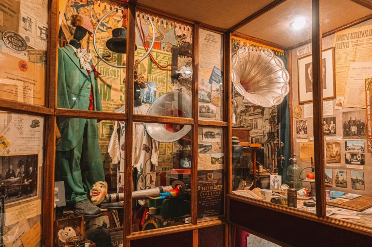 One Street Museum in Kyiv - showcase with vintage costumes and a gramophone