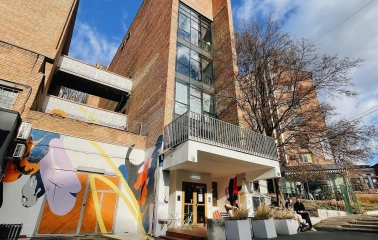 Octo Tower - brick building facade with colorful mural and entrance