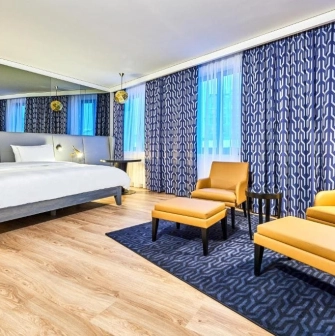 Spacious modern room at the Radisson Blu Hotel in the center of Kyiv with a double bed and a seating area