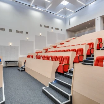 A spacious and well-lit conference hall with rows of chairs at the Bratyslava Hotel in Kyiv