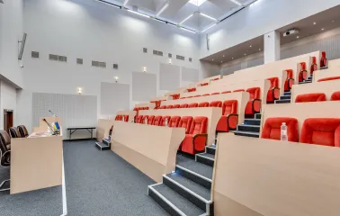 A spacious and well-lit conference hall with rows of chairs at the Bratyslava Hotel in Kyiv