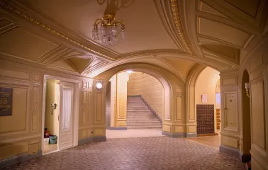 National Opera of Ukraine in Kyiv - elegant corridor with arched beige ceilings and a marble staircase leading to the balconies