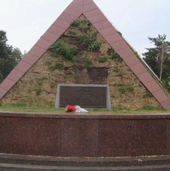 Peremoha Park in Kyiv - Kurgan of Immortality memorial shaped like a grassy pyramid with a dedication plaque