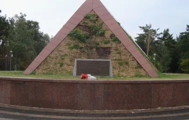 Peremoha Park in Kyiv - Kurgan of Immortality memorial shaped like a grassy pyramid with a dedication plaque