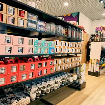 UAmade in Kyiv - neatly arranged store shelves with ceramic mugs with cute animal prints or jokes
