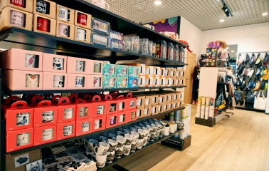 UAmade in Kyiv - neatly arranged store shelves with ceramic mugs with cute animal prints or jokes