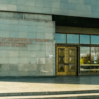 War Museum in Kyiv - monumental stone facade with golden doors at the museum entrance