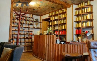 Chaguan in Kyiv - reception with wooden counter and ceiling covered in tea wrappers