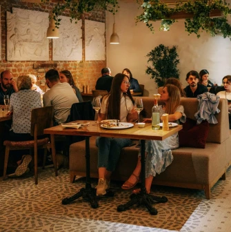 Restaurant Tisto, Syr i Titka Bella - indoor dining area with brick walls and stucco reliefs