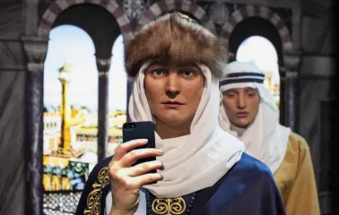 Muzei Stanovlennia Ukrainskoi Natsii in Kyiv - close-up of a realistic wax figure in medieval Kyivan Rus headwear holding a modern smartphone