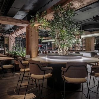 Par Bar - round table with tree in stylish restaurant interior