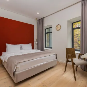 Sophia Hotel - close-up view of a large decorated bed with pillows