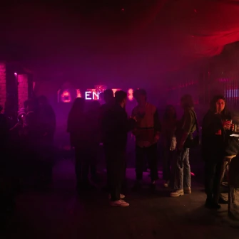A party with dim lighting inside the "Hvlv" bar in Podil, Kyiv