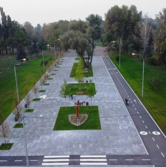 Muromets park - aerial view of the renovated main alley featuring a paved pedestrian promenade, benches, and a marked bicycle lane