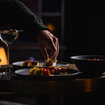 Serving dishes with plates and a cocktail at the restaurant