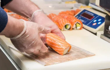 Egersund Seafood - chef preparing salmon rolls at the sushi counter