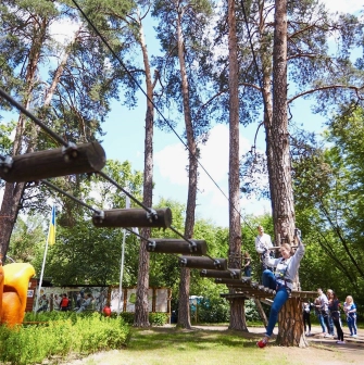 Seiklar Park in Kyiv - large orange squirrel sculpture welcoming visitors near the start of the rope trails surrounded by green foliage