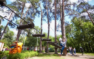 Seiklar Park in Kyiv - large orange squirrel sculpture welcoming visitors near the start of the rope trails surrounded by green foliage