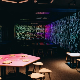 Museum of Mathematics Kuboid in Kyiv - colorful activity zone featuring pink tables with puzzles