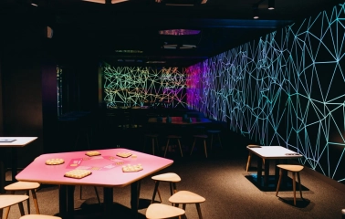 Museum of Mathematics Kuboid in Kyiv - colorful activity zone featuring pink tables with puzzles