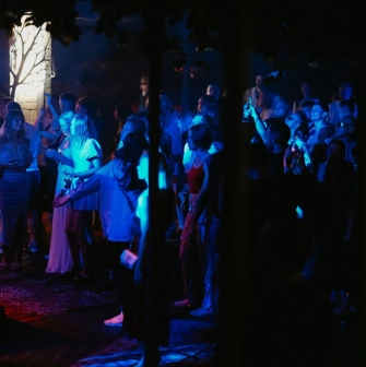 Kureni - people dancing under blue lights at night event