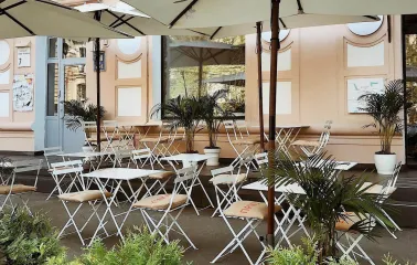 Restaurant Kytaiskyi Pryvit - empty summer terrace with tables chairs and large sun umbrellas