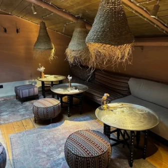 Seliam in Kyiv - attic lounge with straw lamps, low tables and poufs