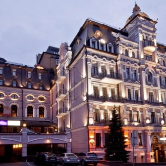 Illuminated facade of the Opera Hotel in Kyiv in the evening