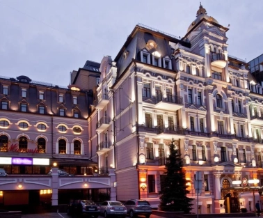 Illuminated facade of the Opera Hotel in Kyiv in the evening