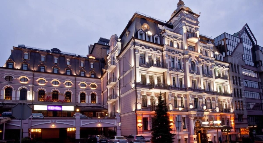 Illuminated facade of the Opera Hotel in Kyiv in the evening