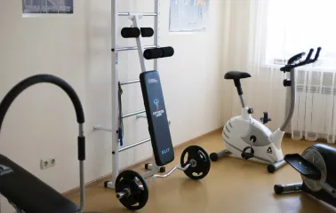 A small gym area with exercise bikes and strength equipment at the Bratyslava Hotel in Kyiv