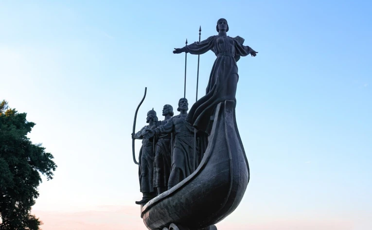 Monument to the Founders of Kyiv - the legendary founders on a boat, overlooking the Dnipro River and cityscape